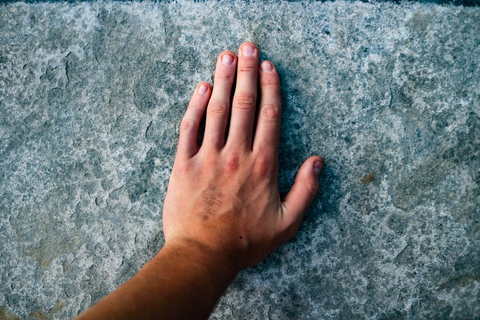 A close-up of a hand holding a Texas Lone Star Card at a grocery store checkout counter