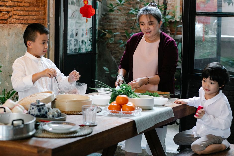 A family preparing a healthy meal together in a bright kitchen