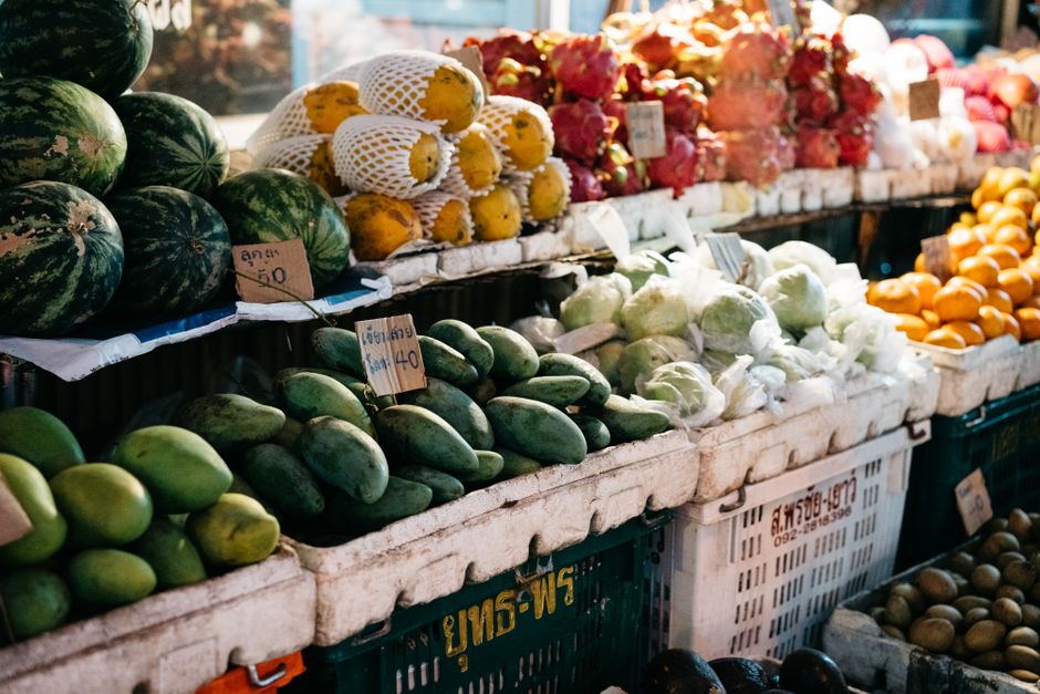 A variety of fresh vegetables and fruits on a kitchen counter
