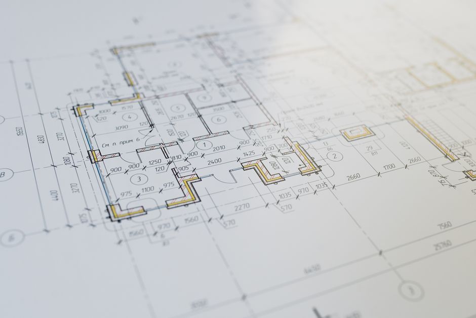 An architectural blueprint of a multi-purpose community center showing outdoor green spaces, classrooms, and a central assembly hall.