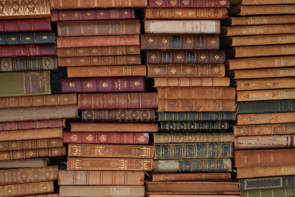 Historical books and modern audio equipment representing the evolution of language perception