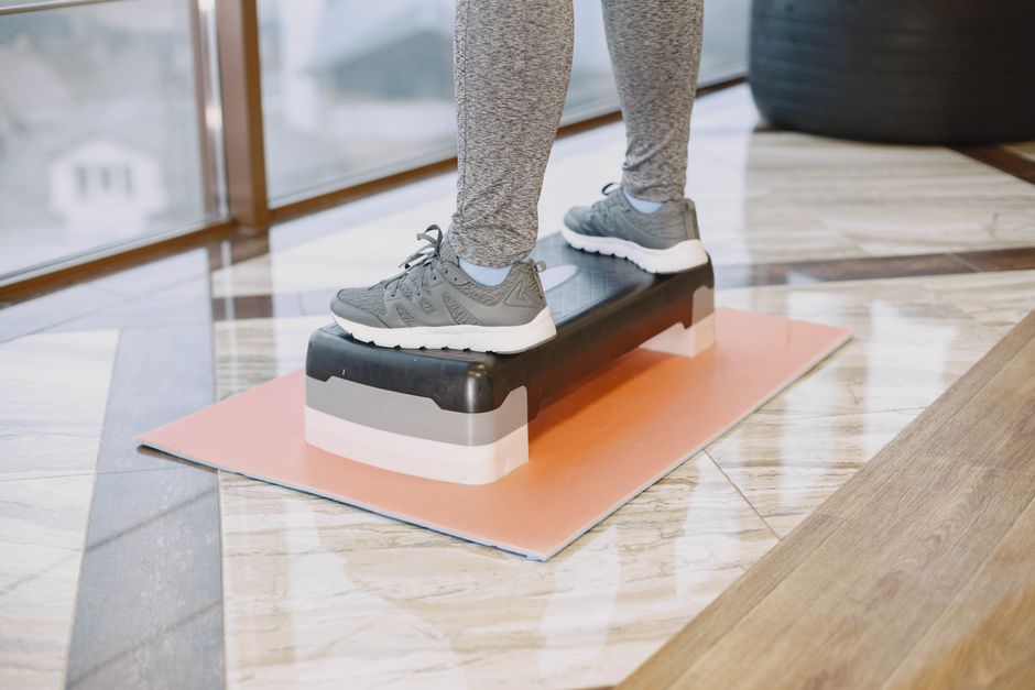 Step-by-step photos showing how to trace a foot and measure the metatarsal girth using a flexible tape measure